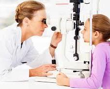 doctor checking girl's eye